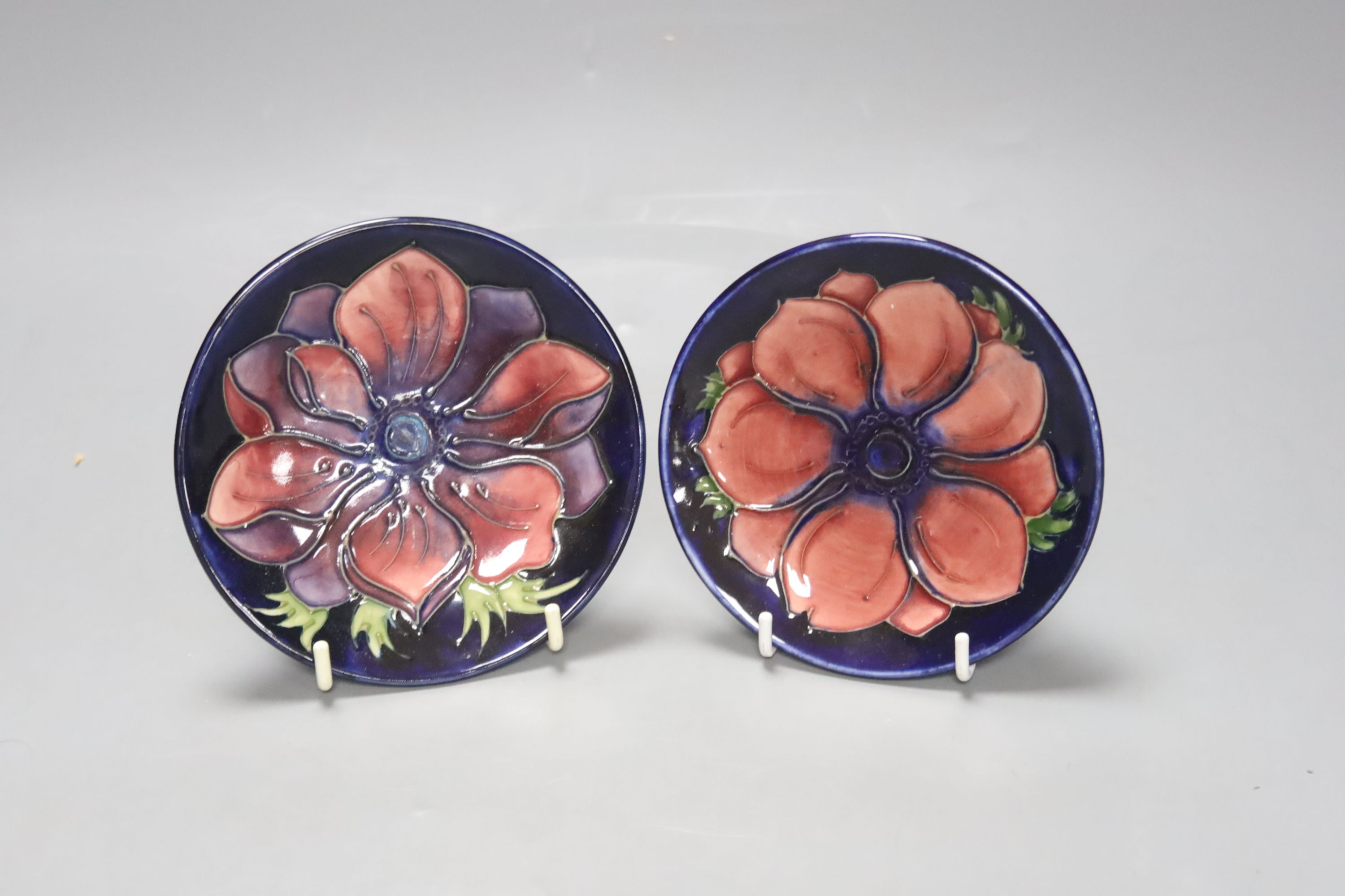 A Moorcroft iris pattern jug and two anenome dishes, together with four Cobridge vases